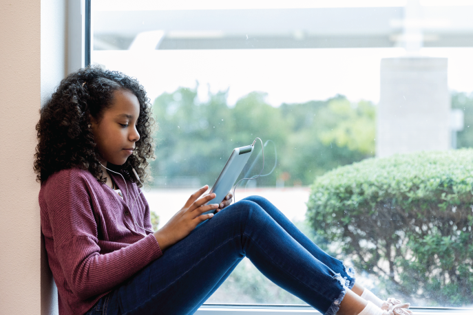 Girl playing a game on a tablet