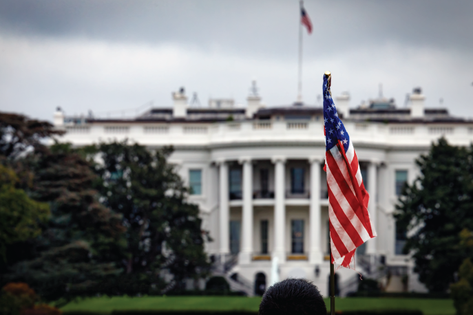 American flag waving in front of the White House