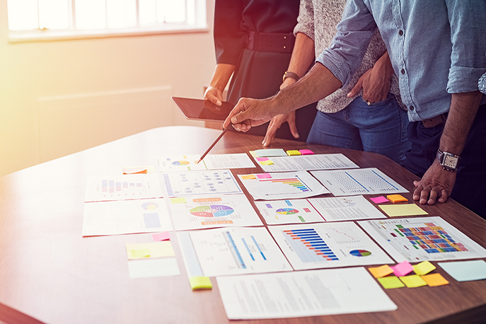 A team looking at spreadsheets and charts