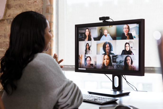 Black woman on a video call with a diverse team