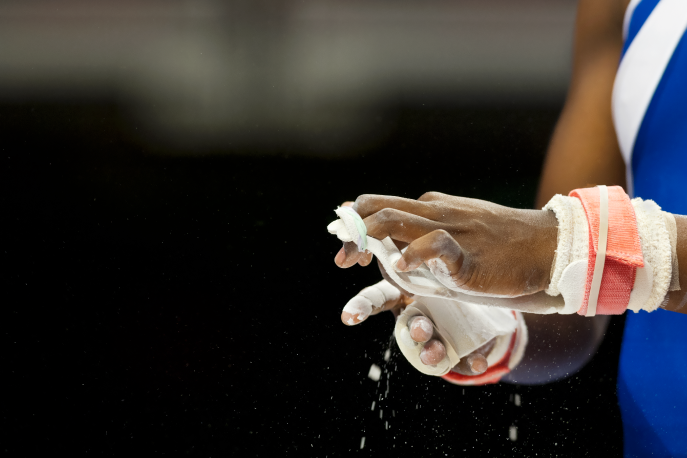 Gymnast applying chalk to her hands