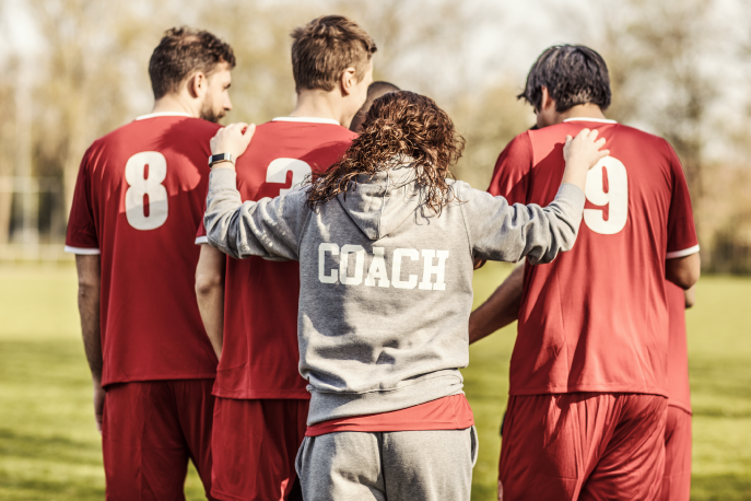 Soccer coach talking with team