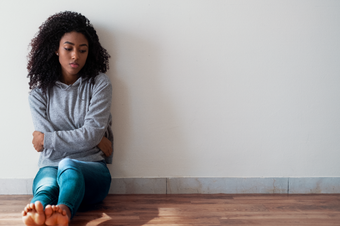 Woman sitting alone on the floor