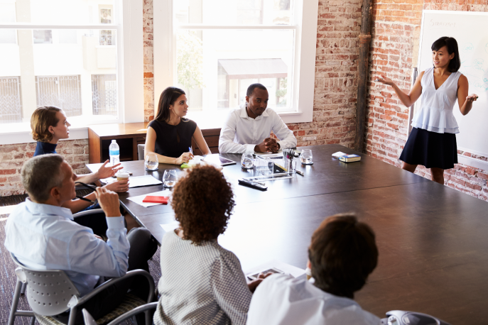 Woman giving a presentation in a boardroom