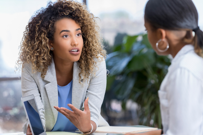 Woman speaking to coworker