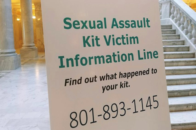 Sign that reads "sexual assault kit victim information line, find out what happened to your kit, 801-893-1145"