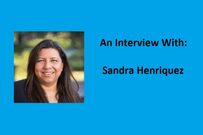 Photo of Sandra Henriquez on light blue background with black text that says "An interview with: Sandra Henriquez"