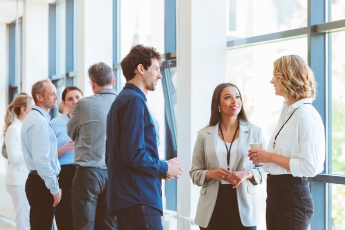 Employees in a conference hall, talking
