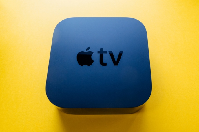 Apple TV device on yellow background