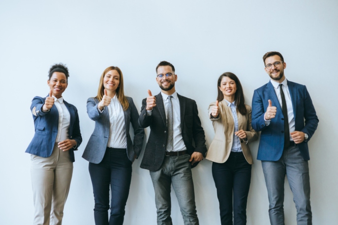 business team members are giving thumbs up to the camera